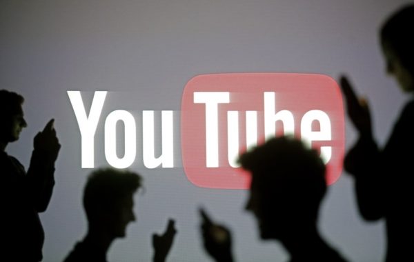 People Are Silhouetted As They Pose With Mobile Devices In Front Of A Screen Projected With A Youtube Logo, In This Picture Illustration Taken In Zenica October 29, 2014. Reuters/Dado Ruvic (Bosnia And Herzegovina - Tags: Business Science Technology Business Logo) - Rtr4C1Ak